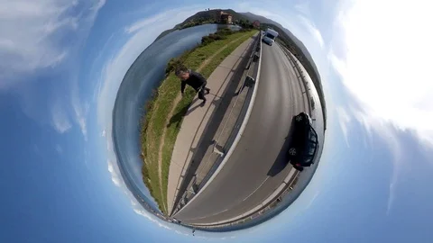 VR360 Effect  - A man runs in the evening on a bridge on a lagoon, Tiny planet Stock Footage 107325418