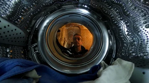 VR360 Effect, A man starts a washing machine, close up view from inside Stock Footage 103162049