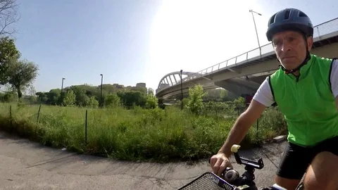 VR360 effect  Rome, a man rides a bike in a  sunny morning near a modern bridge Stock Footage 107135494
