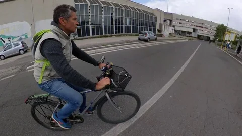 VR360 effect, Rome a man Rides a bike in a suburban area, cloudy day  Stock Footage 107609394