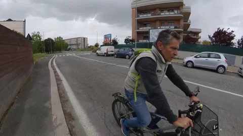 VR360 effect, Rome a man Rides a bike in a suburban area, cloudy day  Stock Footage 107609400