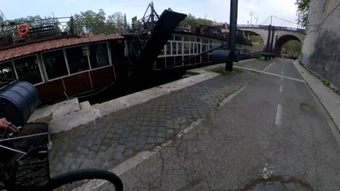 VR360 effect Rome, Riding a bike along the river with bridges and houseboats Stock Footage 107135570