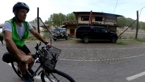VR360 effect Rome, Riding a bike along the river with bridges and houseboats Stock Footage 107136177