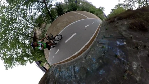 VR360 Extreme POV effect A biker rides on the bicycle lane Along the river Rome  Stock Footage 107135772