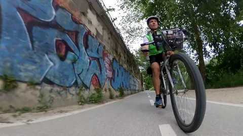 VR360 Extreme POV effect A biker rides on the bicycle lane Along the river Rome  Stock Footage 107135988