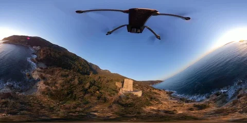 VR360 Flight around an ancient tower on the sea at sunset Stock Footage 106314620