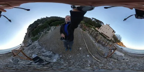 VR360 A man with a Drone, Aerial view of a Takeoff from a beach at sunset Stock Footage 106310452