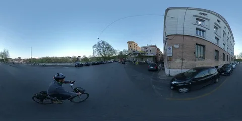 VR360 A man rides a Bike at sunset in the traffic, ancient Rome - Lungotevere Stock Footage 106576369