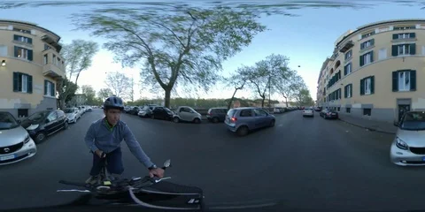 VR360 A man rides a Bike at sunset in the traffic, ancient Rome - Lungotevere Stock Footage 106576383