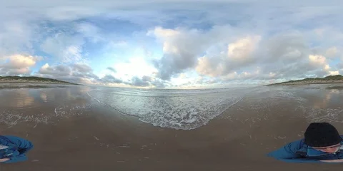 VR360, Man on the sandy beach of the North Sea at dusk, Denmark, VR Stock Footage 117708906