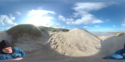 VR360, Man standing on dune, sand drift, storm, North Sea, VR Stock Footage 117716813