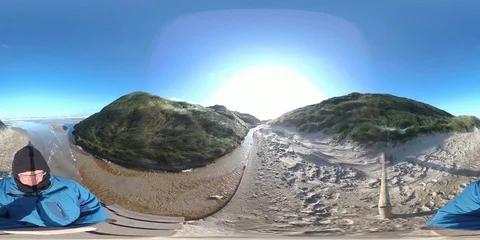 VR360, Man standing on sand drift, storm on the North Sea, VR Stock Footage 117706953