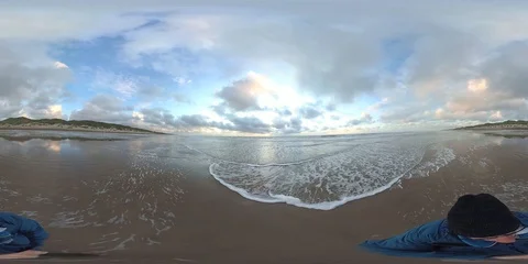 VR360, Man walks on the sandy beach of the North Sea at dusk, Denmark, VR Stock Footage 117708713