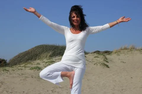 Vrksasana on the baech Stock Photos