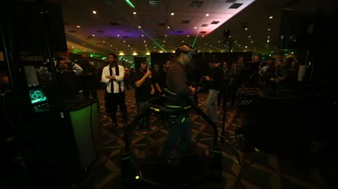 VRLA Expo - Man in Virtuix Omni VR Treadmill Stock Footage 59581265