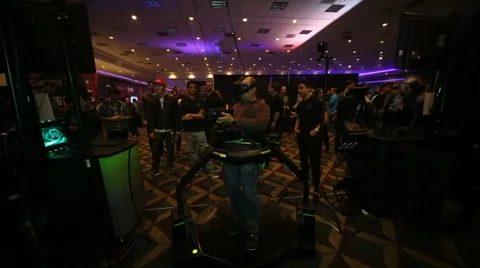 VRLA Expo - Man in Virtuix Omni VR Treadmill Stock Footage 59581663