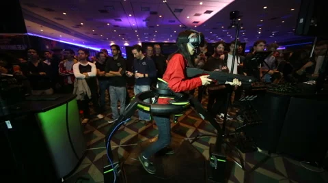 VRLA Expo - Woman in Virtuix Omni VR Treadmill Slow Motion Video stock 59579966