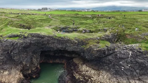 Vsitors explore the rugged landscape in Bundoran, County Donegal, Ireland. Stock Footage 342716086