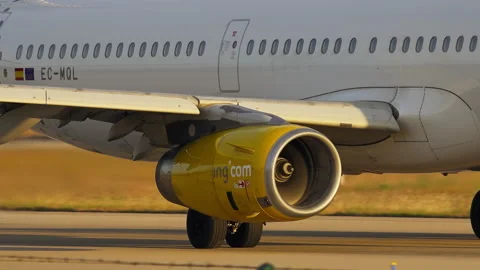 Vueling jet engine close up while airliner taxis on runway Stock Footage 337800129