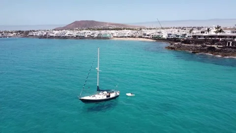 Vuelo de dron sobre un velero en Playa Blanca en Lanzarote en 4k Stock Footage