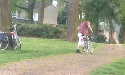 VV1309 Drunk guy tries to ride bike Stock-Footage 129460074