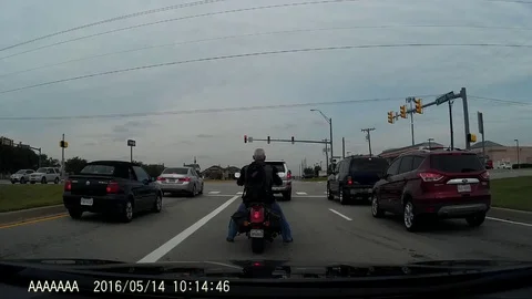 VV1319 Motorcycle takes a tumble at intersection Stock-Footage 129827904