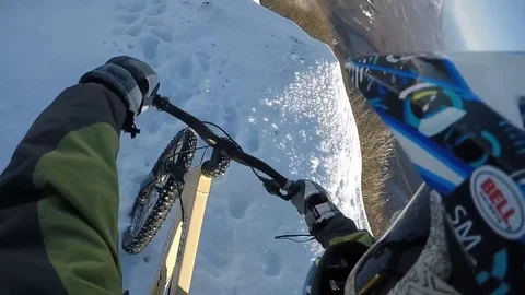 VV2024 Snow cyclist slides down mountain face Stock-Footage 129459407