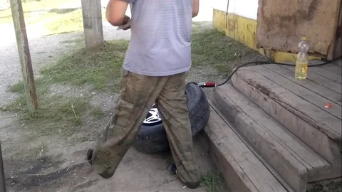 VV2084 - Fitting a tire with fire Stock-Footage 129455653