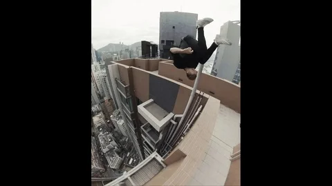 VV3571 Front flip onto to highrise ledge Stock Footage 129459177