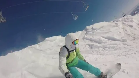 VV832 Snowboarder falls but manages to keep hold of selfie stick! Stock Footage 129456808