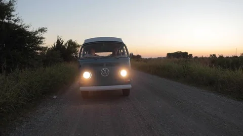 VW Bus Camper Van Driving Down Dirt Road At Night Video stock 118152808