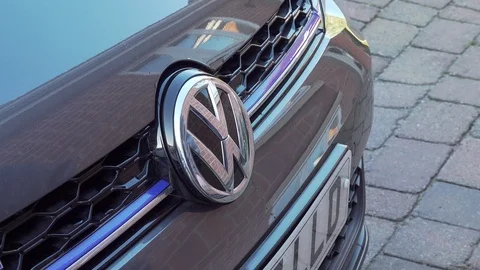 VW plugin hybrid model Gte car is connected to home wall charging point Video stock 122026530