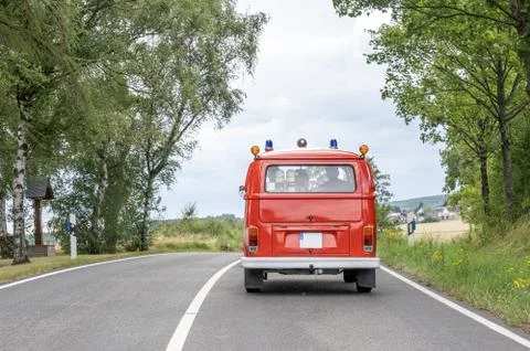 VW T1 fire engine red firefigther car Oldtimer classic car drivin on the Road Stock Photos