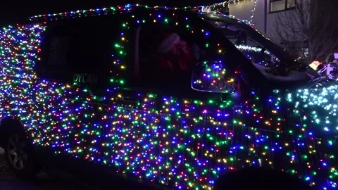 VW vans transformed into festive light display delight two-year-old boy Stock Footage 323326278
