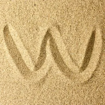 W handwriting in the sand Stock Photos