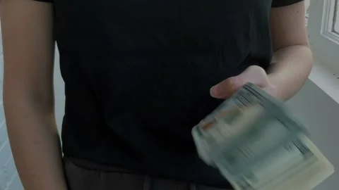 A wad of 100 dollar bills in hands Stock Footage 304634738