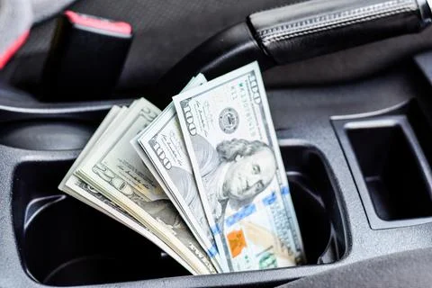 Wad of dollars inside the car. Foto stock
