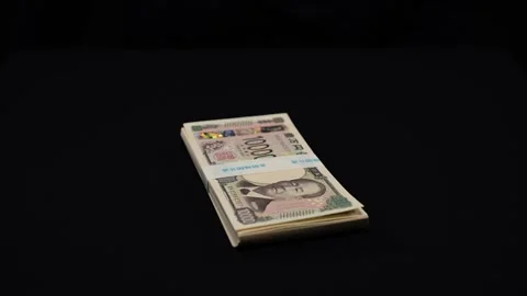 Wad of new banknotes placed on a black background Stock Footage 336765730