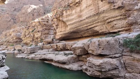 Wadi Ash Shab is a dramatic canyon in Oman Stock Footage 320439752