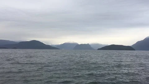 Wading lake waters on cloudy mountain landscape Stock Footage 136339967