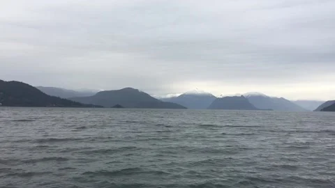 Wading lake waters on cloudy mountain landscape Stock Footage 136339972