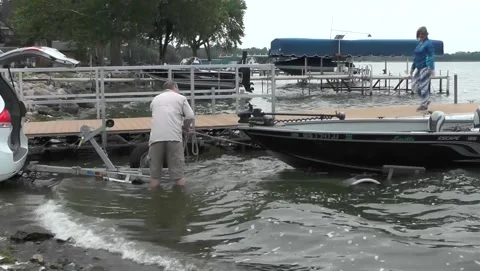 Wading Man Pulls Boat On Trailer Stock Footage 201110599