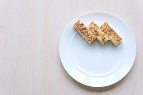 Wafer biscuit on white background Slice of plain cheesecake on white plate and Stock Photos