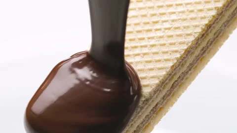 Wafer with chocolate splash, chocolate icing with waffle bar Stock Footage