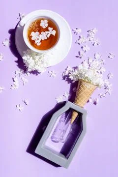 Wafer cone with hydrangea on a purple background. Delicate still life with fl Stock Photos