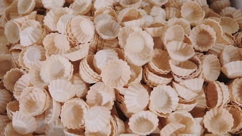 Waffle baskets fall on heap for following packaging stage Stock Footage 124892522