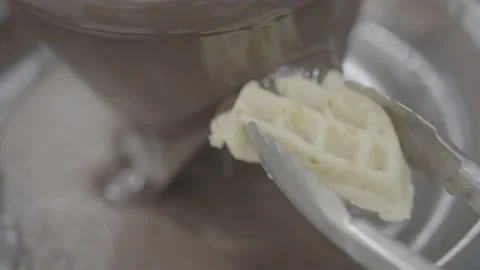 Waffle being generously coated with chocolate Stock Footage 218599117