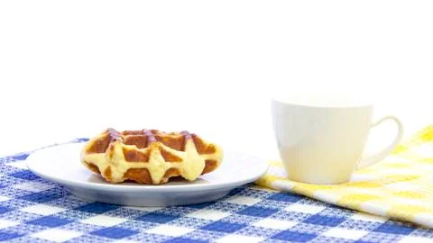 Waffle bread glazed with cup of coffee on table mat Stock Photos
