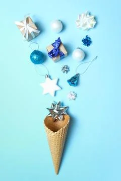 Waffle cone with christmas elements on blue background. Stock Photos