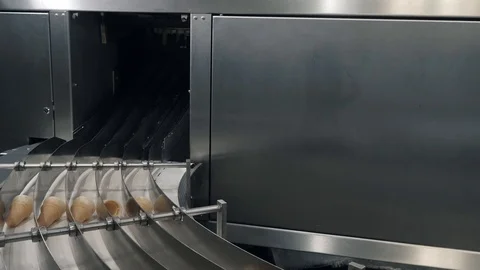 Waffle cones arrive on moving conveyor at plant workshop Stock Footage 124892510